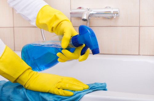 Technician using deep carpet cleaning equipment on a stained carpet
